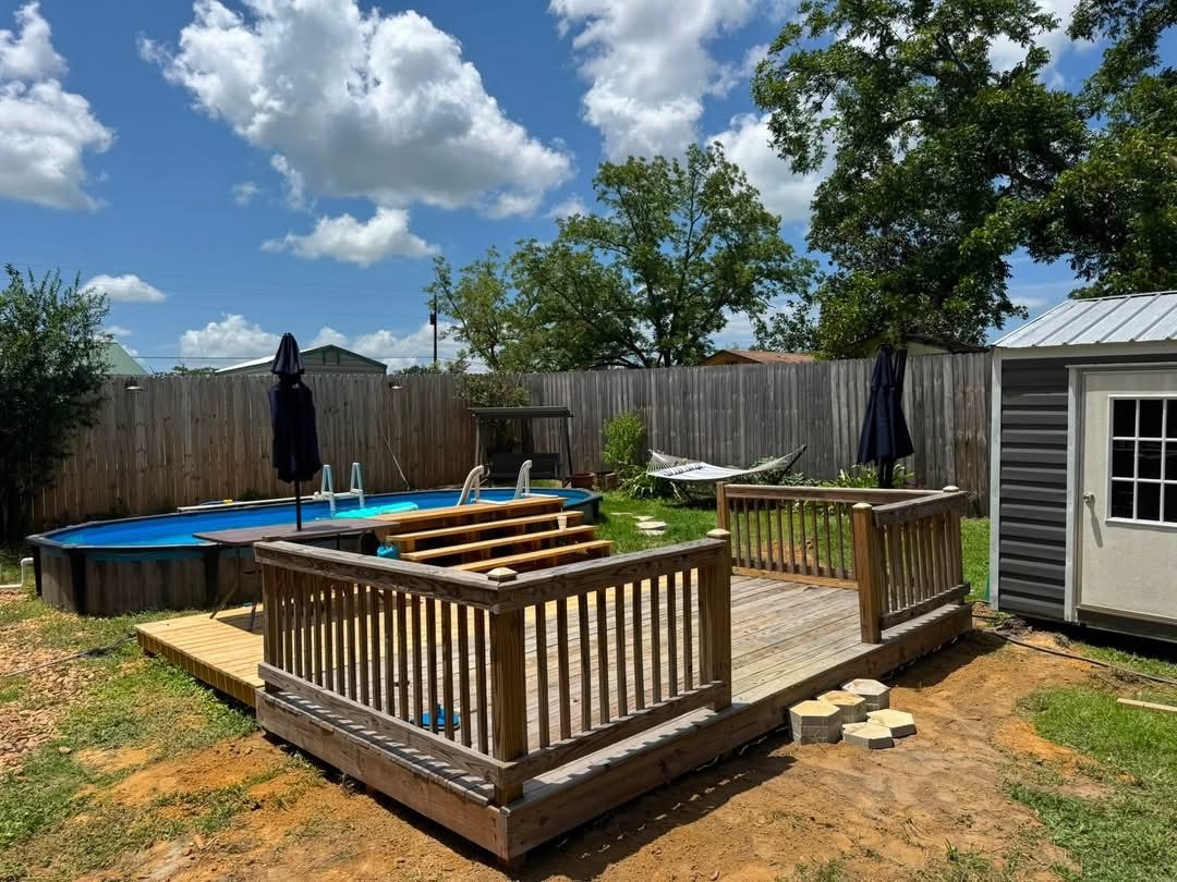 A completed wood deck and pool area in a homeowner's yard